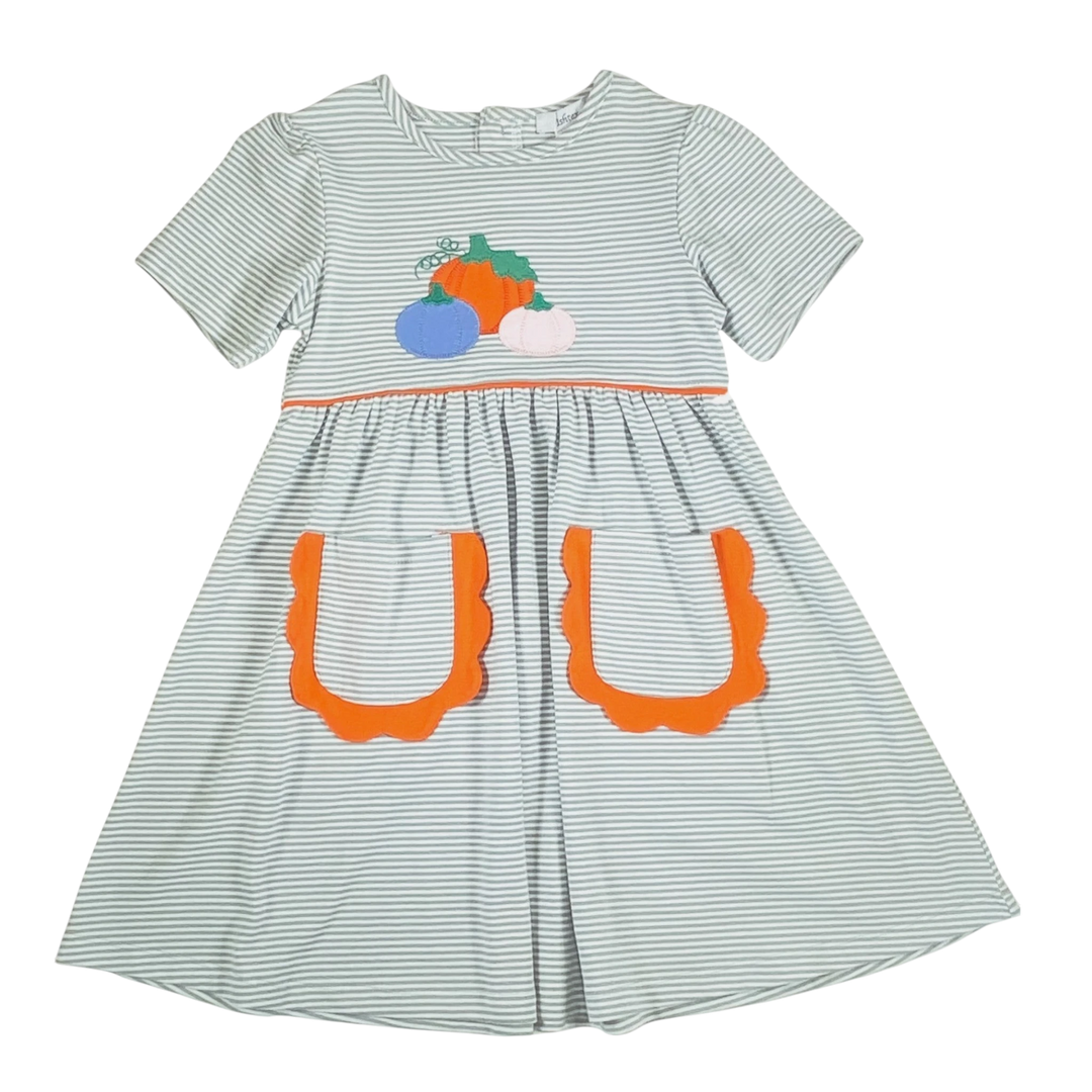 That Store green striped dress for girls featuring a pumpkin applique and orange scalloped pockets for fall.