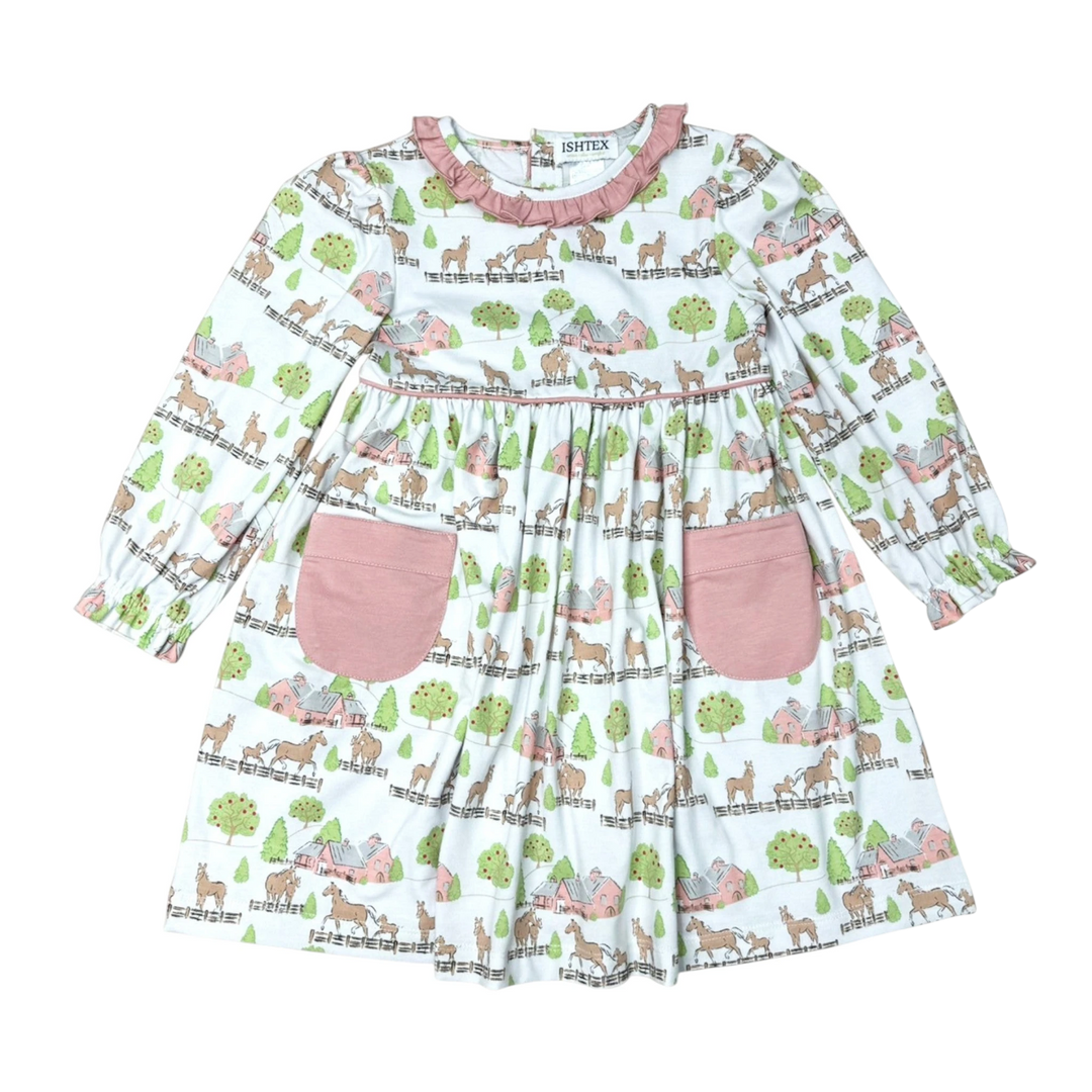 That Store pink cotton dress with horse and barn print, featuring a ruffled collar and two front pockets.