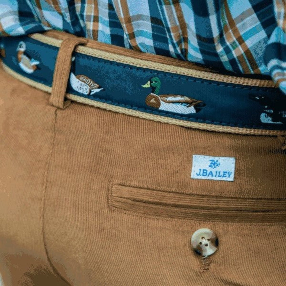 That Store J Bailey belt featuring a navy blue strap with embroidered mallard ducks worn with tan corduroy pants