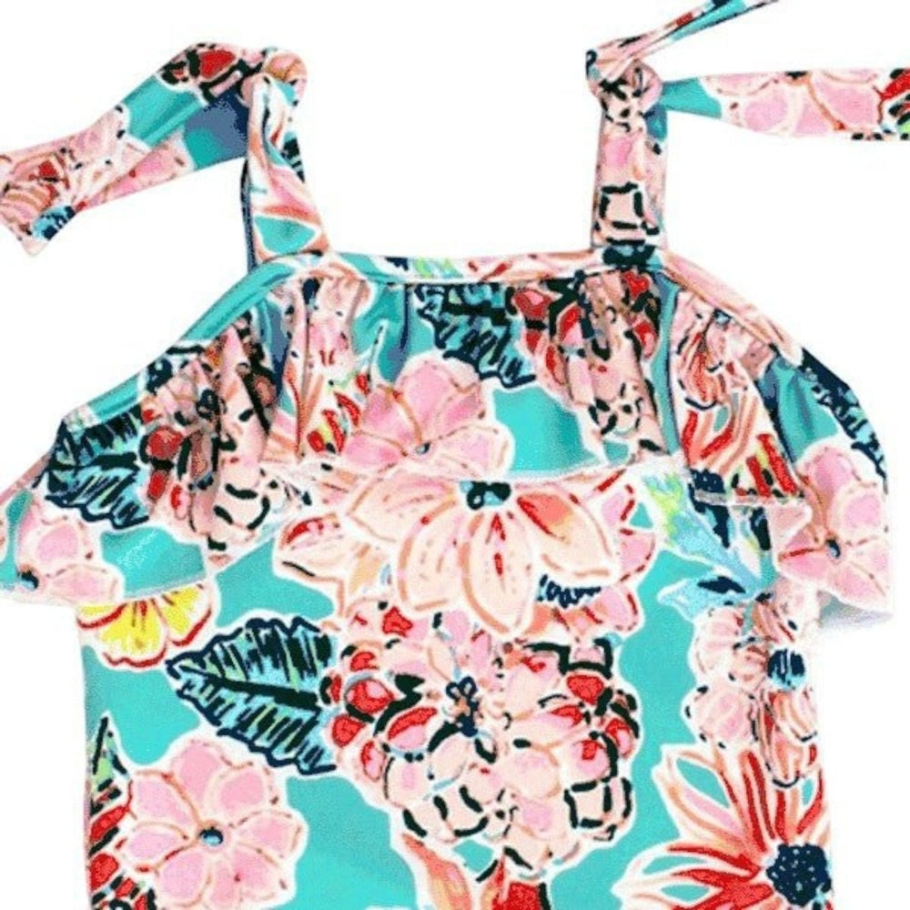 That Store J Bailey one-piece swimsuit in turquoise and pink floral print with ruffled front and tie-shoulder straps.
