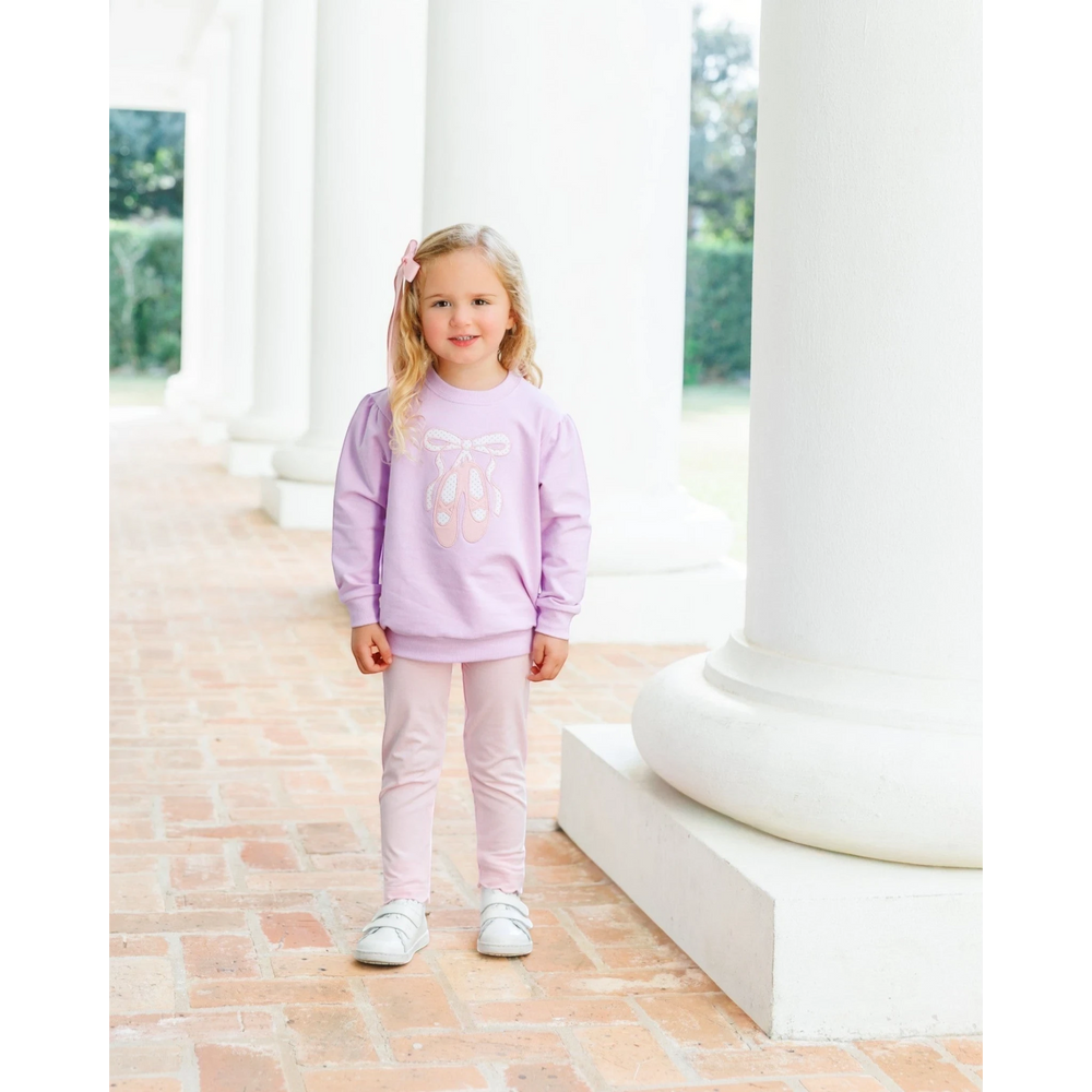 That Store lavender French terry pullover with ballet shoe embroidery worn by a young girl with a pink hair bow.