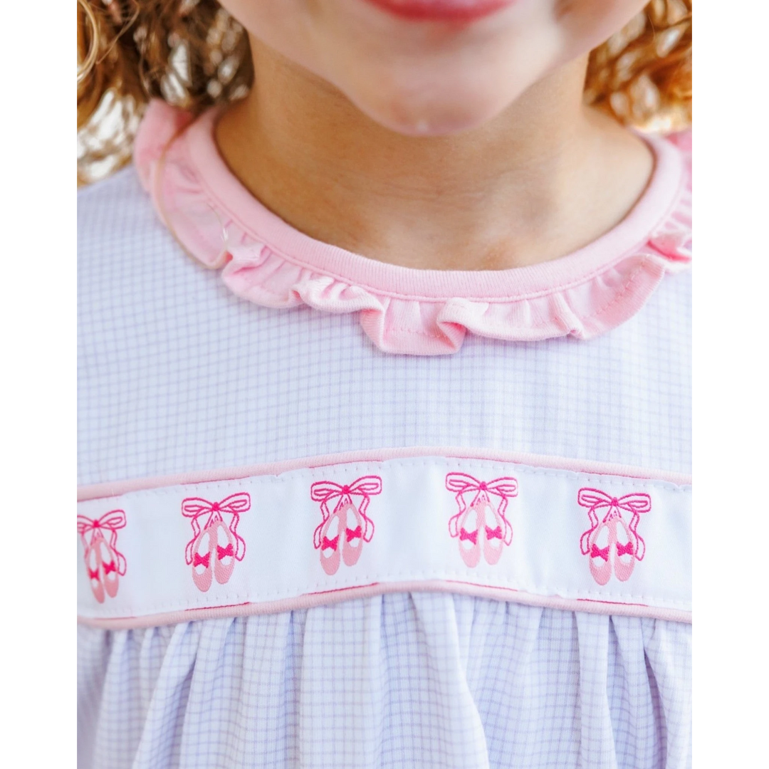 That Store lavender windowpane dress with pink ballet shoe embroidery and a ruffled collar on a young girl
