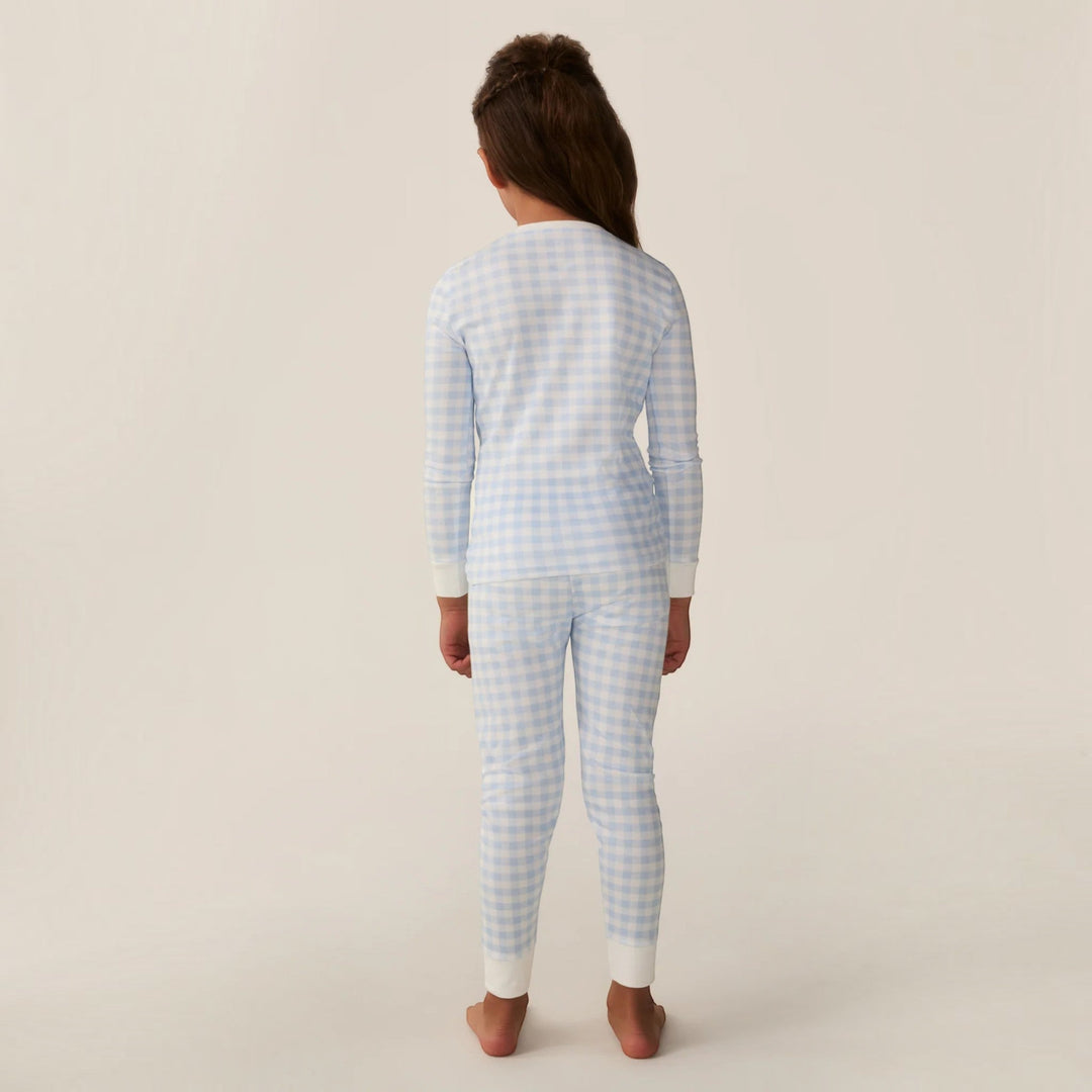 Child wearing That Store light blue gingham Pima cotton long sleeve pajama set, back view showing snug fit design.