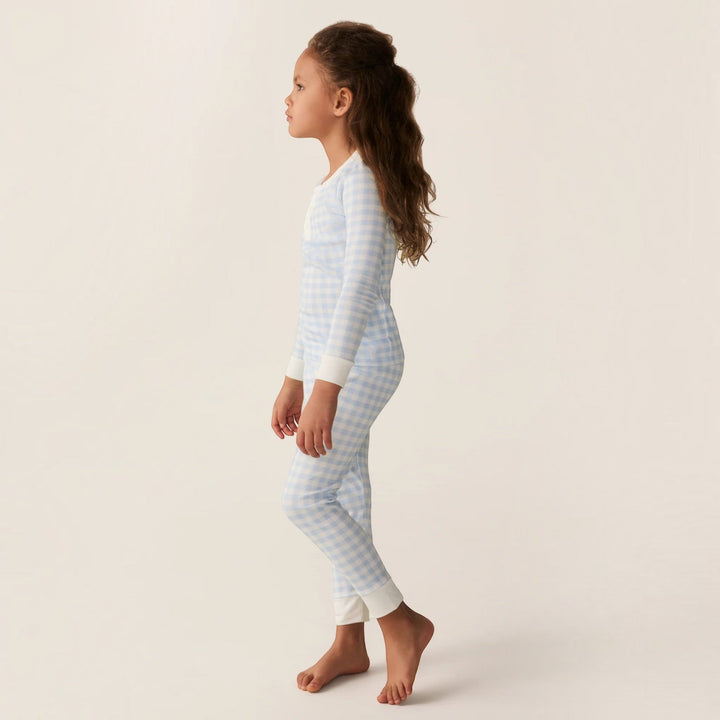 Young girl wearing a That Store light blue gingham Pima cotton long sleeve pajama set with a snug fit