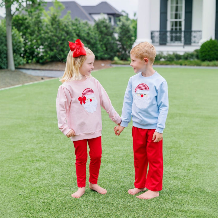 That Store boys light blue French terry pullover with Santa applique worn by a child standing next to a sibling.