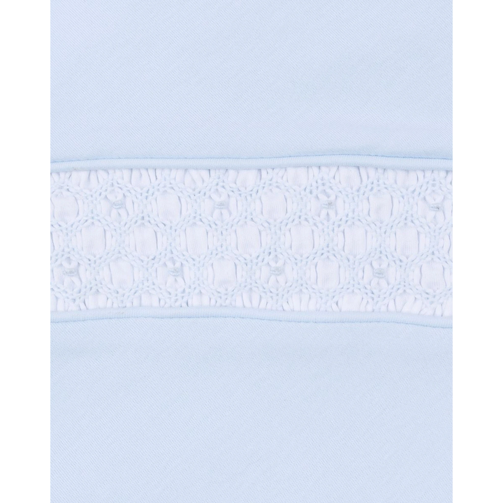 Close-up of That Store light blue Pima cotton baby footie featuring intricate white hand-smocked detailing on the chest.