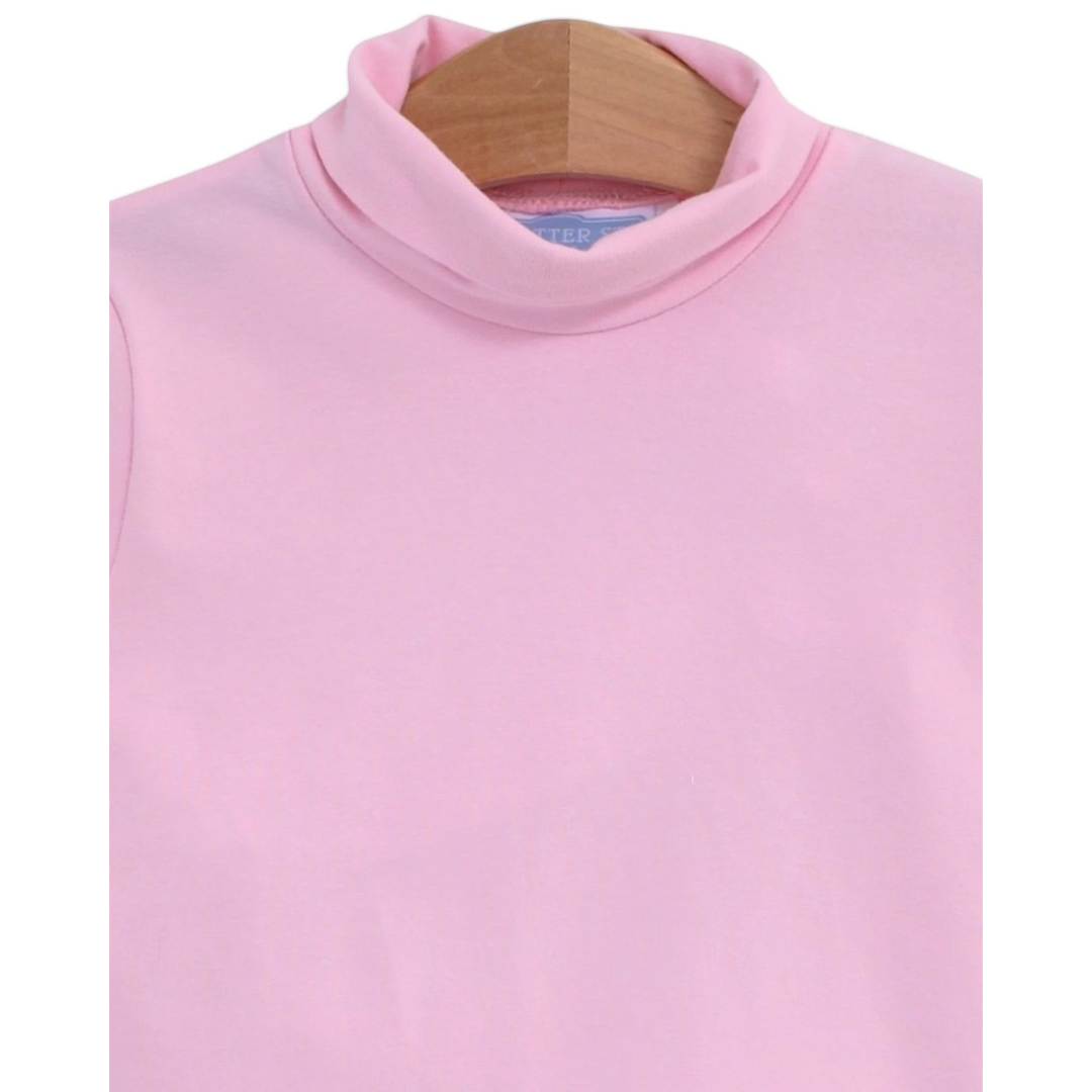 That Store light pink girls turtleneck made from soft cotton spandex blend on a wooden hanger