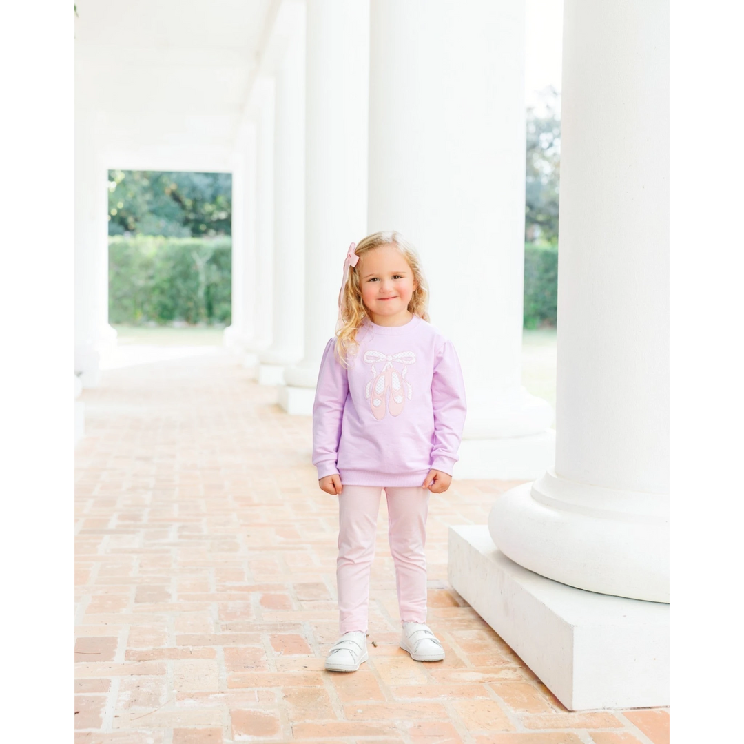 That Store light pink scalloped leggings worn by a young girl with a matching ballet-themed sweatshirt