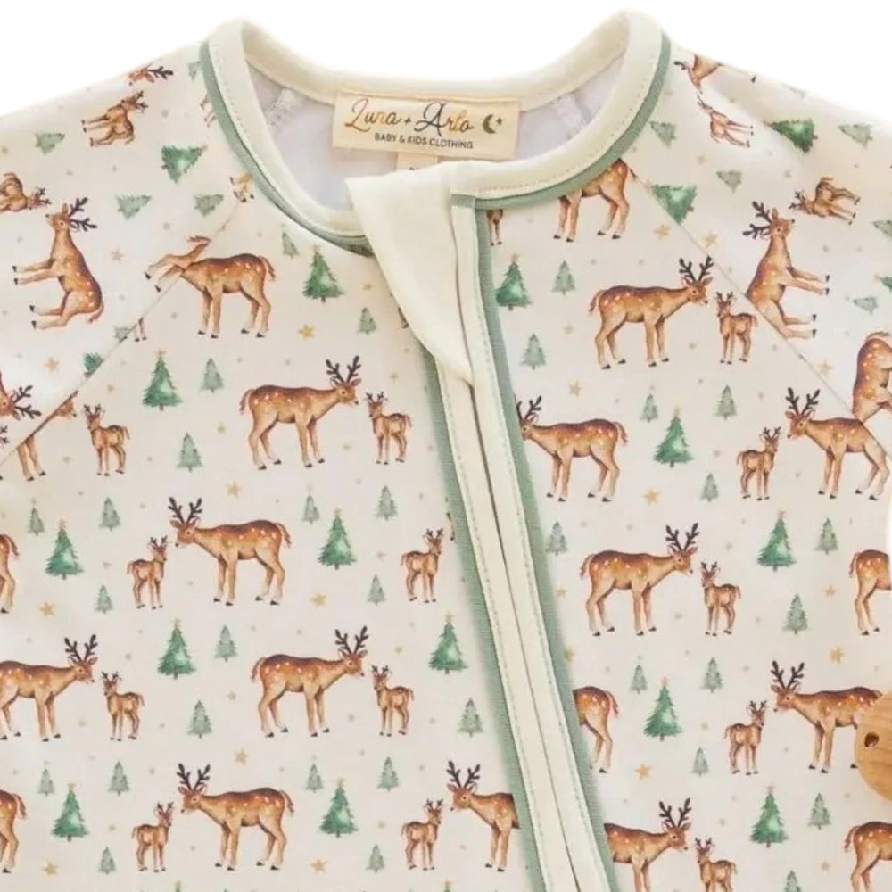 That Store Luna & Arlo ivory Pima cotton playsuit with woodland deer and evergreen tree print and moss green trim.