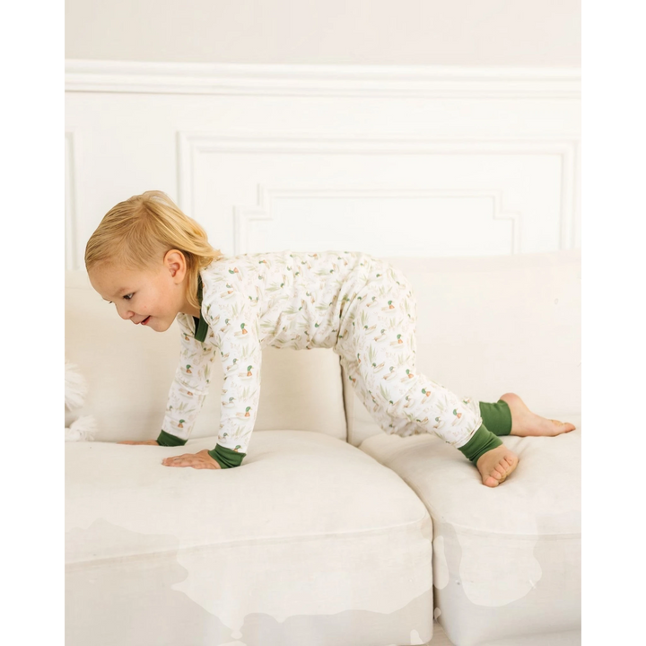 Toddler crawling on a white sofa wearing That Store Mallard&