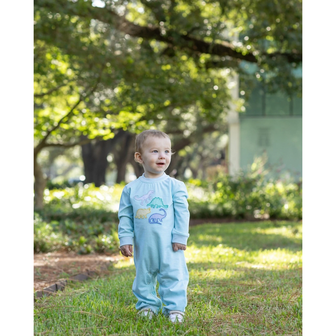 That Store mint striped cotton romper with dinosaur appliqué worn by a toddler standing in a sunny park