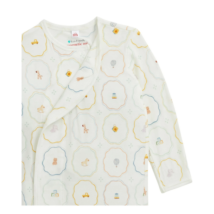 That Store modal magnetic newborn gown in white with a colorful nursery toy print and long sleeves