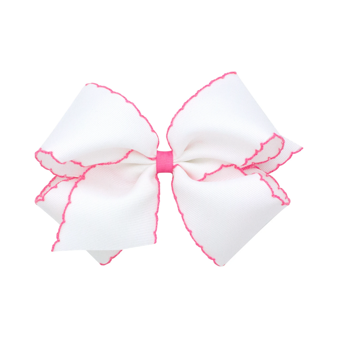That Store Moonstitch medium grosgrain hair bow in white with pink contrasting stitched edges and a no-slip clip.