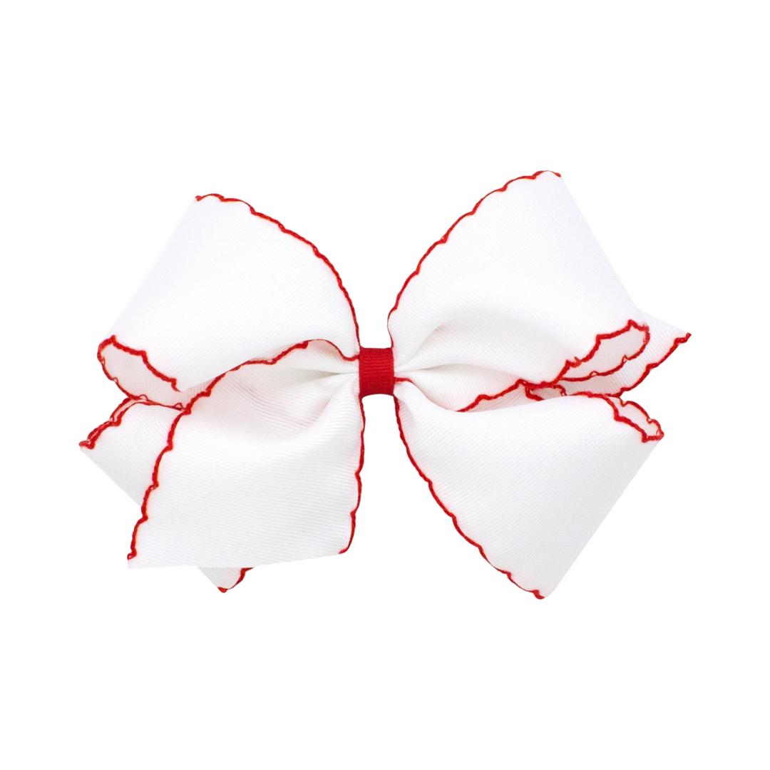 That Store Moonstitch medium grosgrain hair bow in white with red contrasting scalloped edges and a no-slip clip.