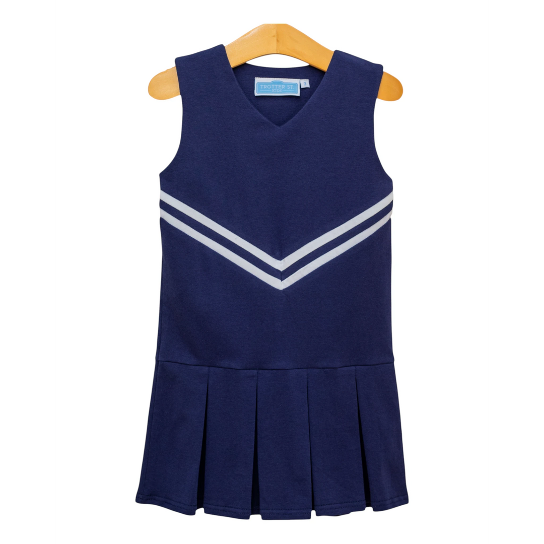 That Store navy cheer uniform dress with white chevron stripes and a pleated skirt on a wooden hanger