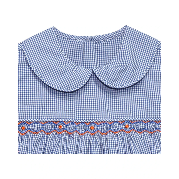 That Store girls bubble in navy and white gingham with a peter pan collar and orange and blue geometric smocking.