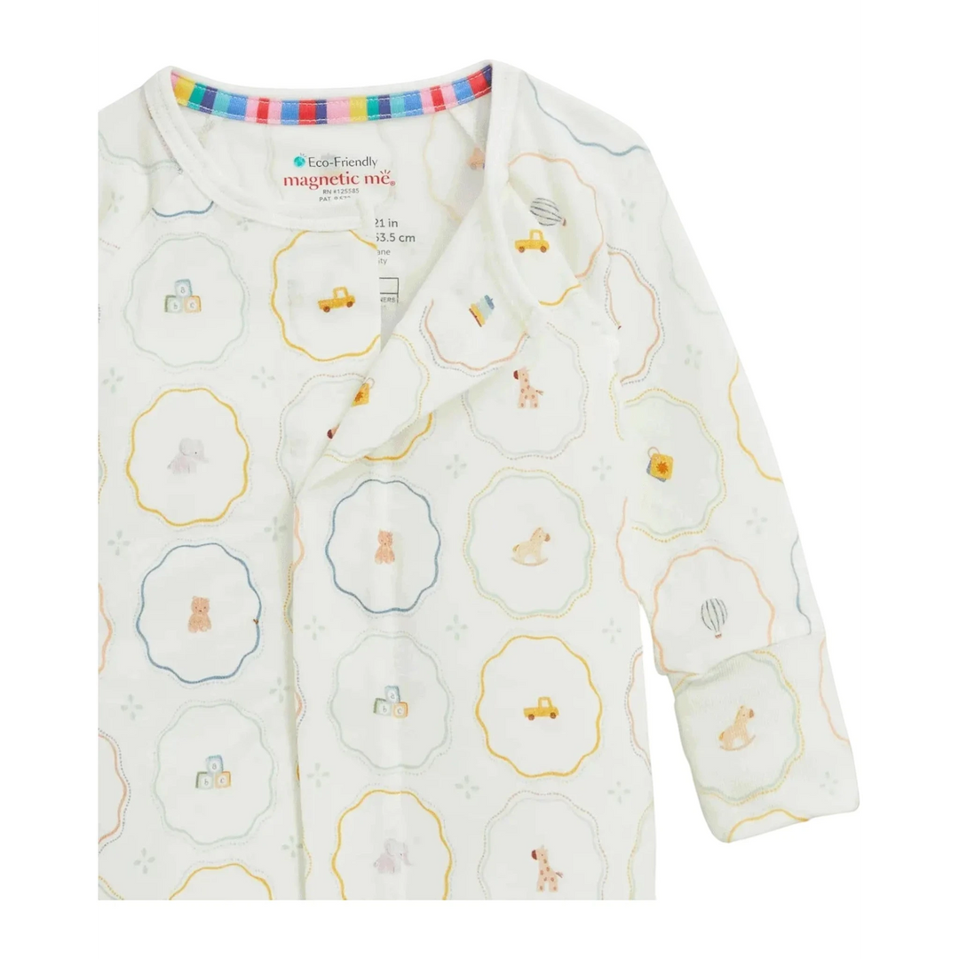 That Store Nursery Magic modal baby footie with magnetic closures and colorful nursery toy print on white fabric