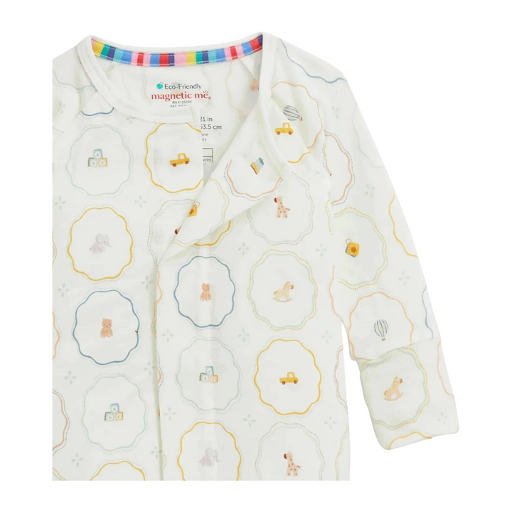 That Store Nursery Magic modal baby footie with magnetic closures and colorful nursery toy print on white fabric