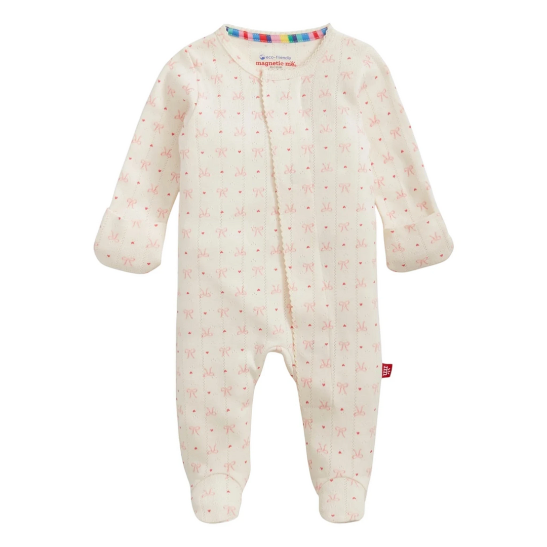 That Store organic cotton pointelle baby footie sleeper in cream with a delicate red heart and bow pattern.