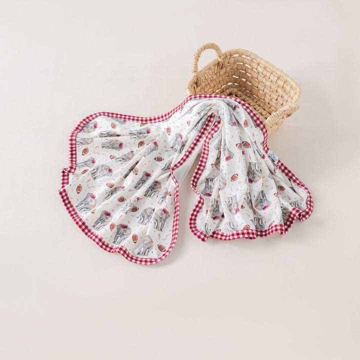 That Store organic cotton muslin swaddle blanket with elephant and football print and red gingham trim