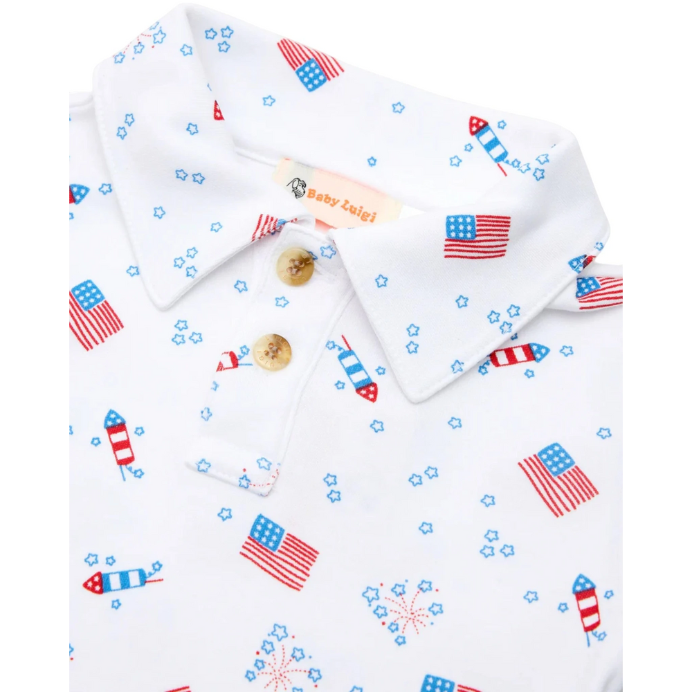 That Store boys polo shirt in white cotton with a red, white, and blue American flag and fireworks patriotic print.