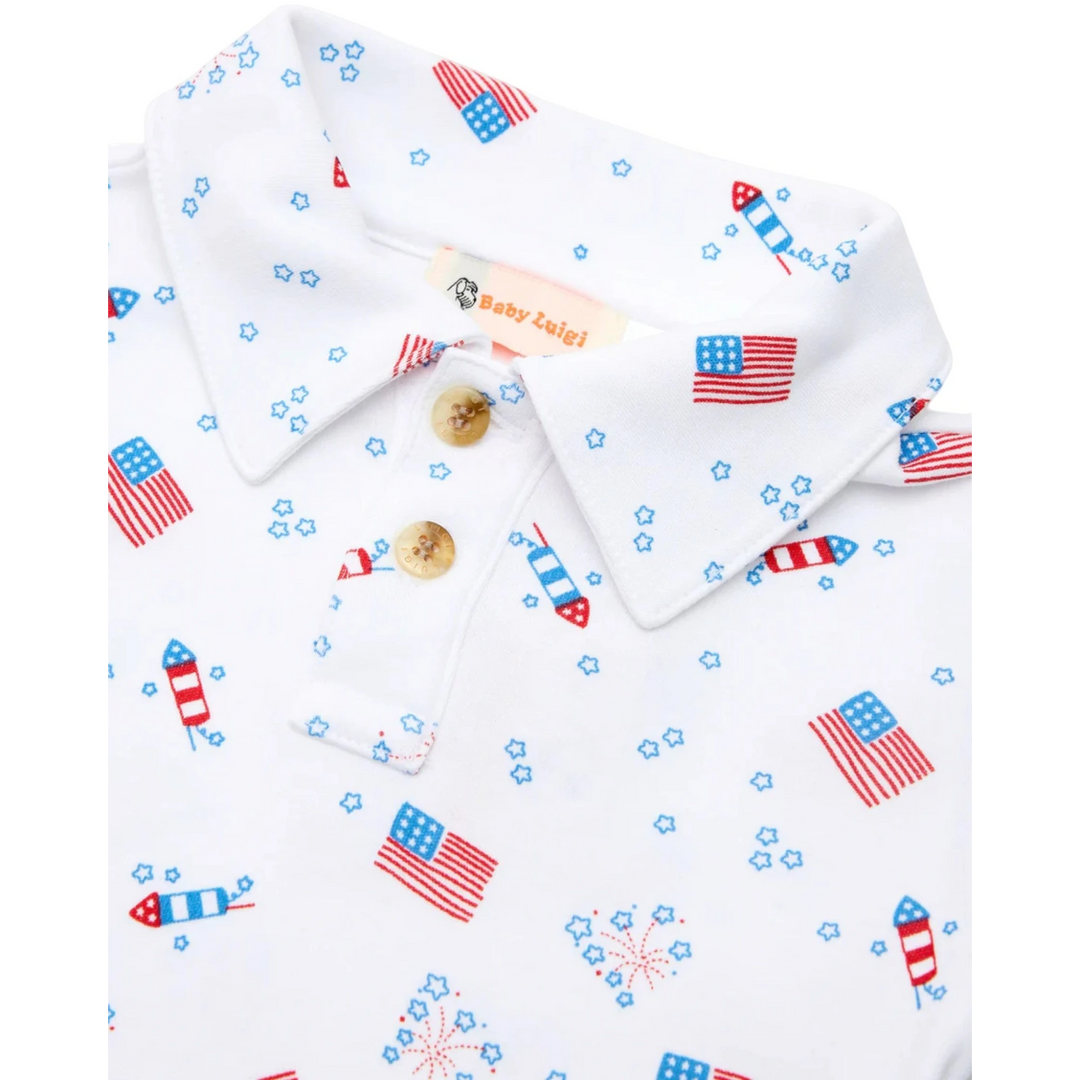 That Store boys polo shirt in white cotton with a red, white, and blue American flag and fireworks patriotic print.