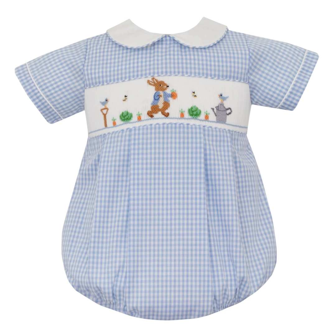 That Store smocked Peter Rabbit bubble romper in blue gingham with a white Peter Pan collar and garden embroidery.