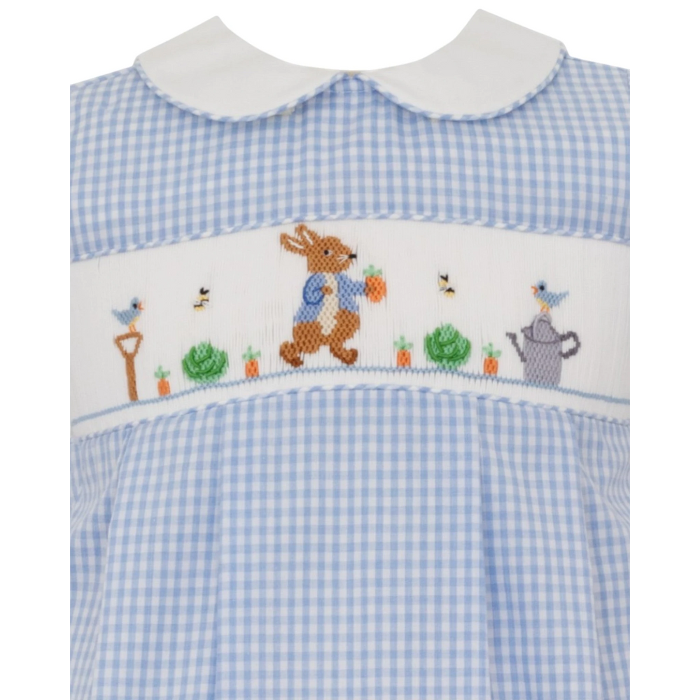 That Store blue gingham bubble romper with Peter Rabbit smocking, white collar, and garden embroidery for boys.