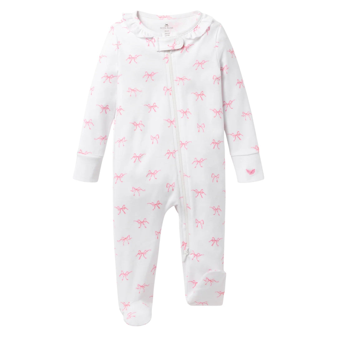 That Store baby romper in white Pima cotton with pink bow print, ruffle collar, and front zipper closure.