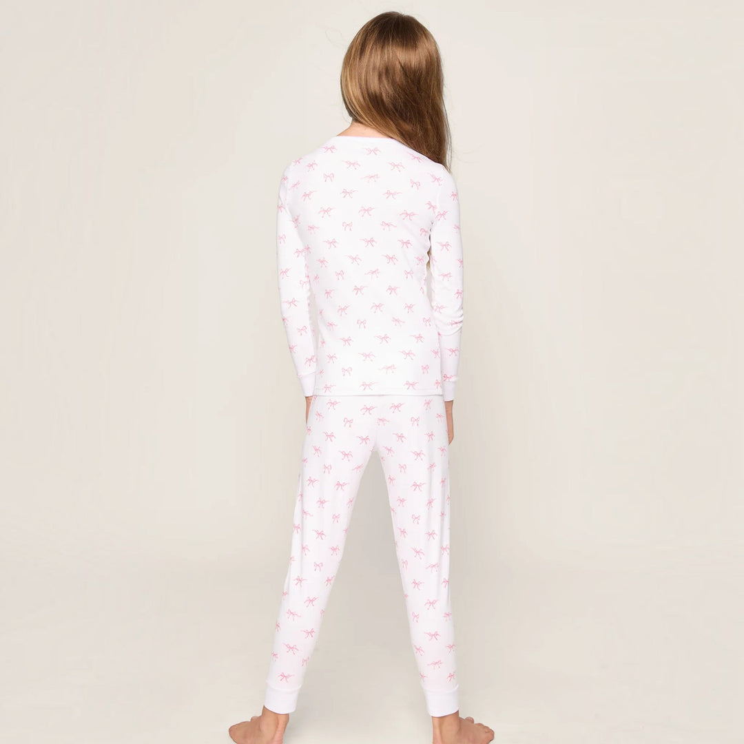 Back view of a child wearing That Store Pima cotton pajama set in white with a pink Blushing Bows print.