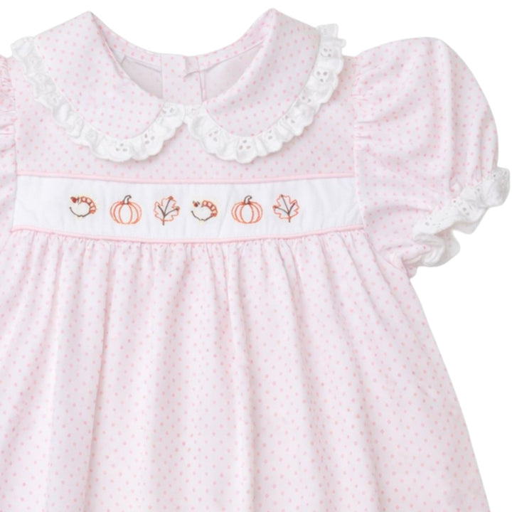 That Store pink dot Alice dress with fall leaf and pumpkin embroidery, white eyelet collar, and puff sleeves.