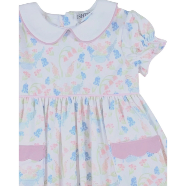 That Store primrose pink floral dress with white peter pan collar, puff sleeves, and scalloped pocket detail.