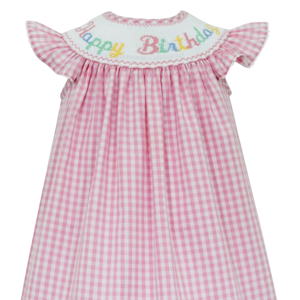 That Store pink gingham smocked bishop dress with Happy Birthday embroidery and white ric rac angel wing sleeves.