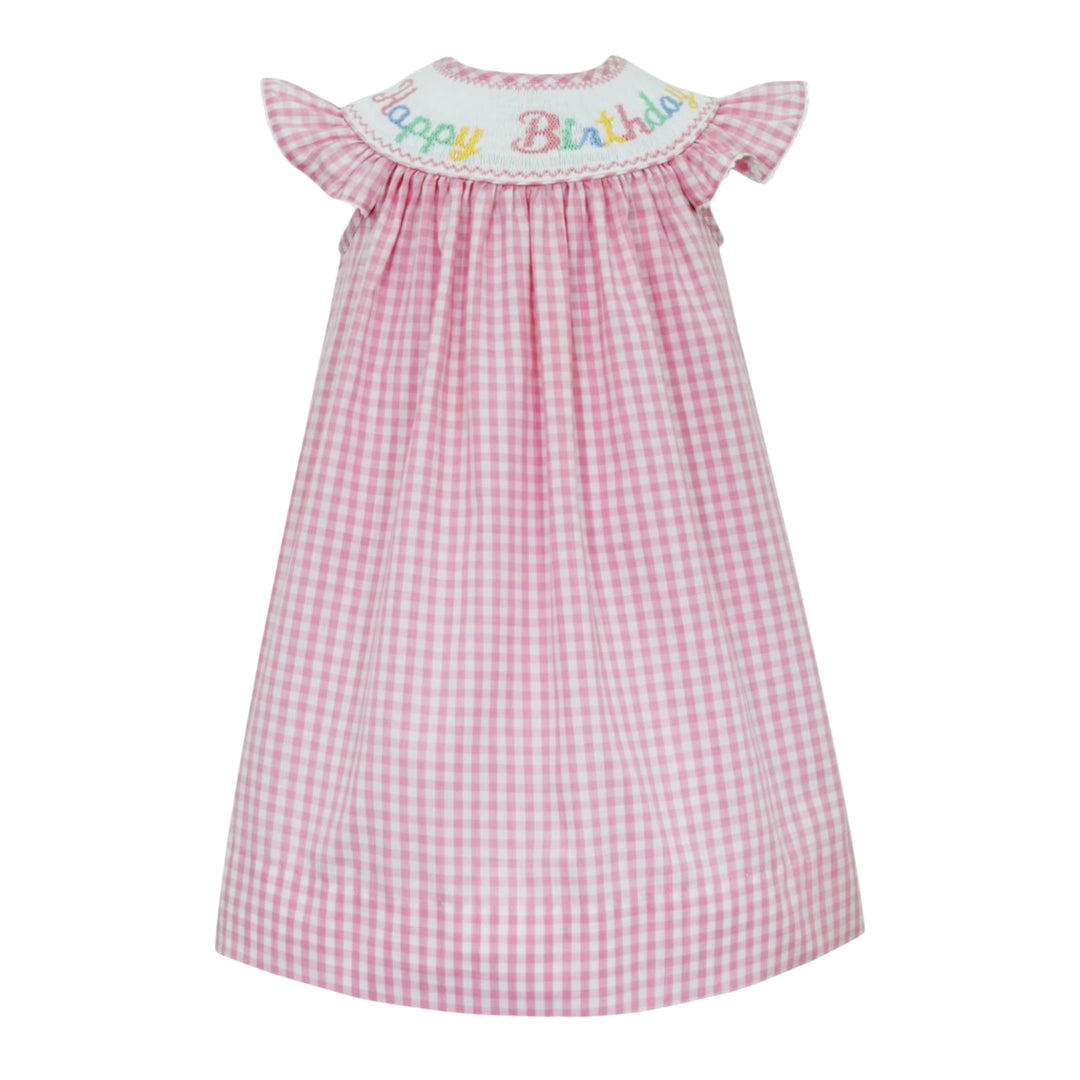 That Store pink gingham smocked bishop dress with Happy Birthday embroidery and white ric rac angel wing sleeves.