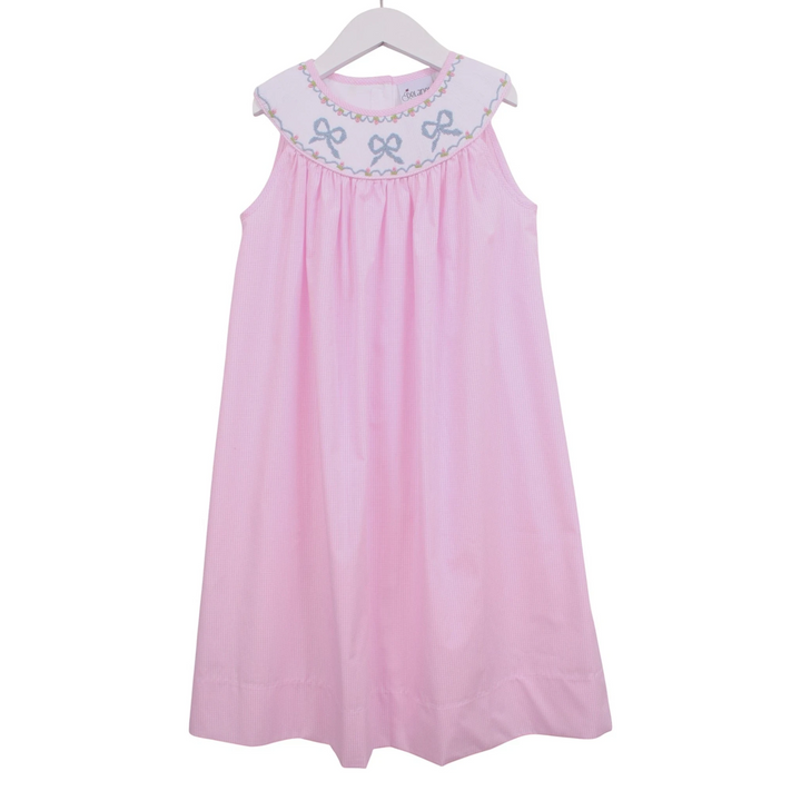 That Store pink gingham sleeveless dress with a smocked yoke featuring embroidered blue bow details on a white collar