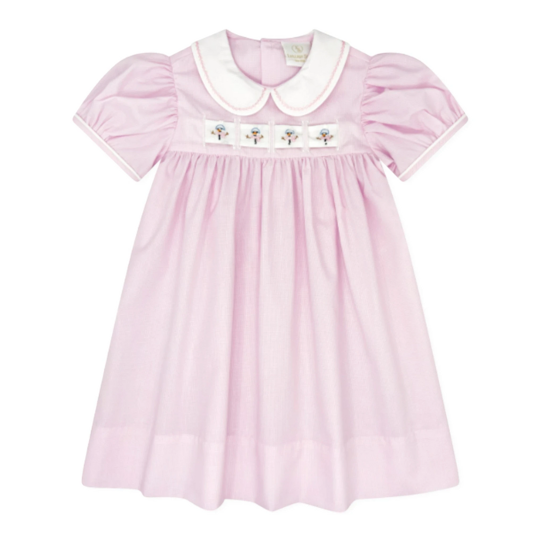That Store pink mini gingham dress with a white Peter Pan collar and interchangeable holiday ribbon detail