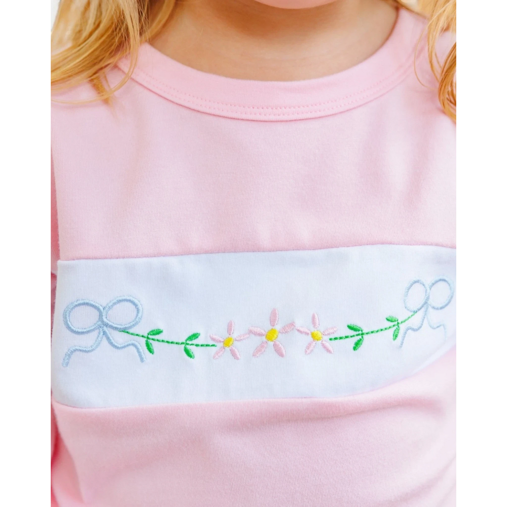 That Store pink girls jogger set featuring a white chest panel with embroidered blue bows and pink flowers