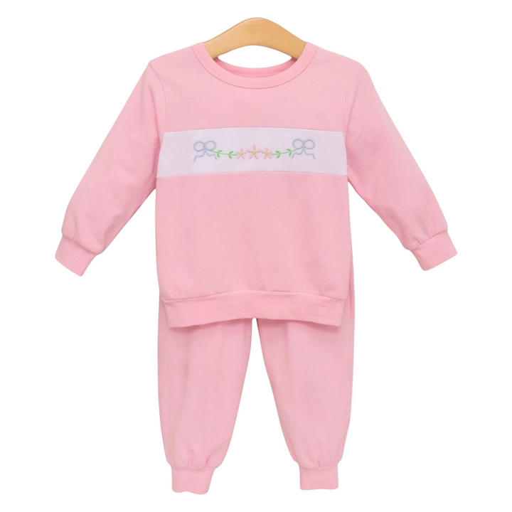 That Store pink girls jogger set featuring a long-sleeve sweatshirt with embroidered bows and flowers on a white band.