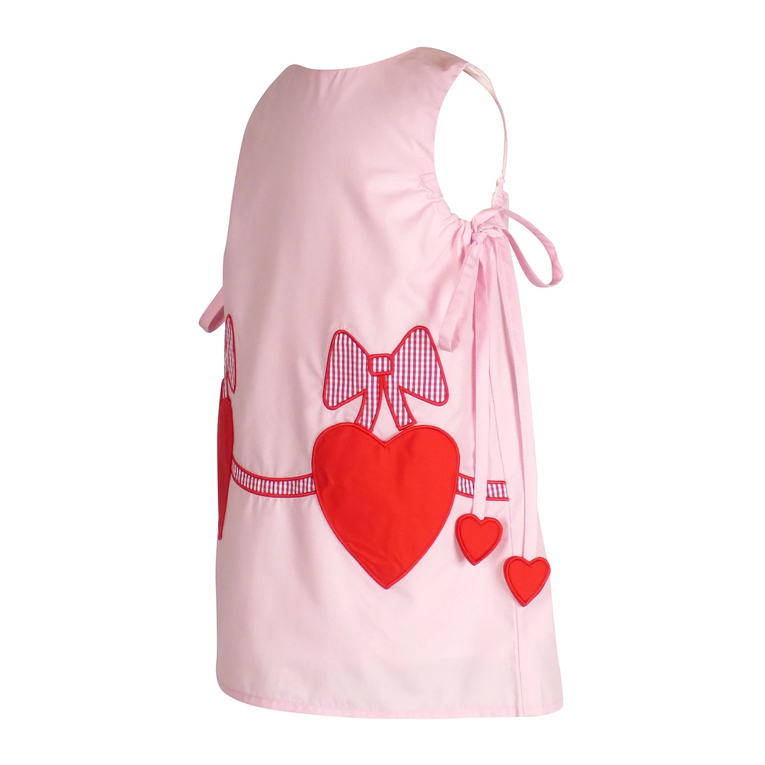 That Store pink jumper with red heart applique, gingham bow detail, and side tie closure for little girls.