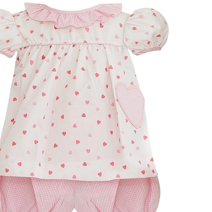 That Store Anabelle pink bloomer set with heart print, ruffled collar, and heart-shaped pocket detail.