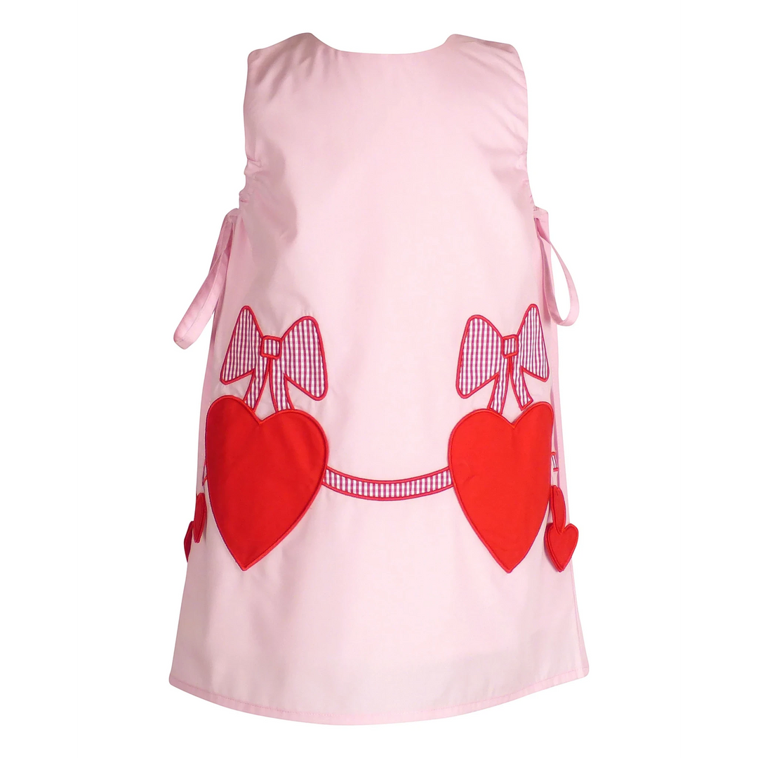 That Store Emma Pink jumper featuring red heart pockets and gingham bow appliques for a sweet, playful look.