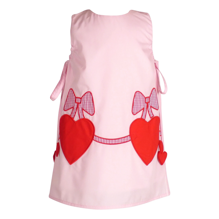 That Store Emma Pink jumper featuring red heart pockets and gingham bow appliques for a sweet, playful look.
