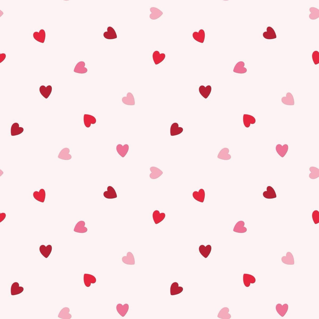 That Store Anabelle pink bloomer set fabric featuring a repeating pattern of small red and light pink heart patches.