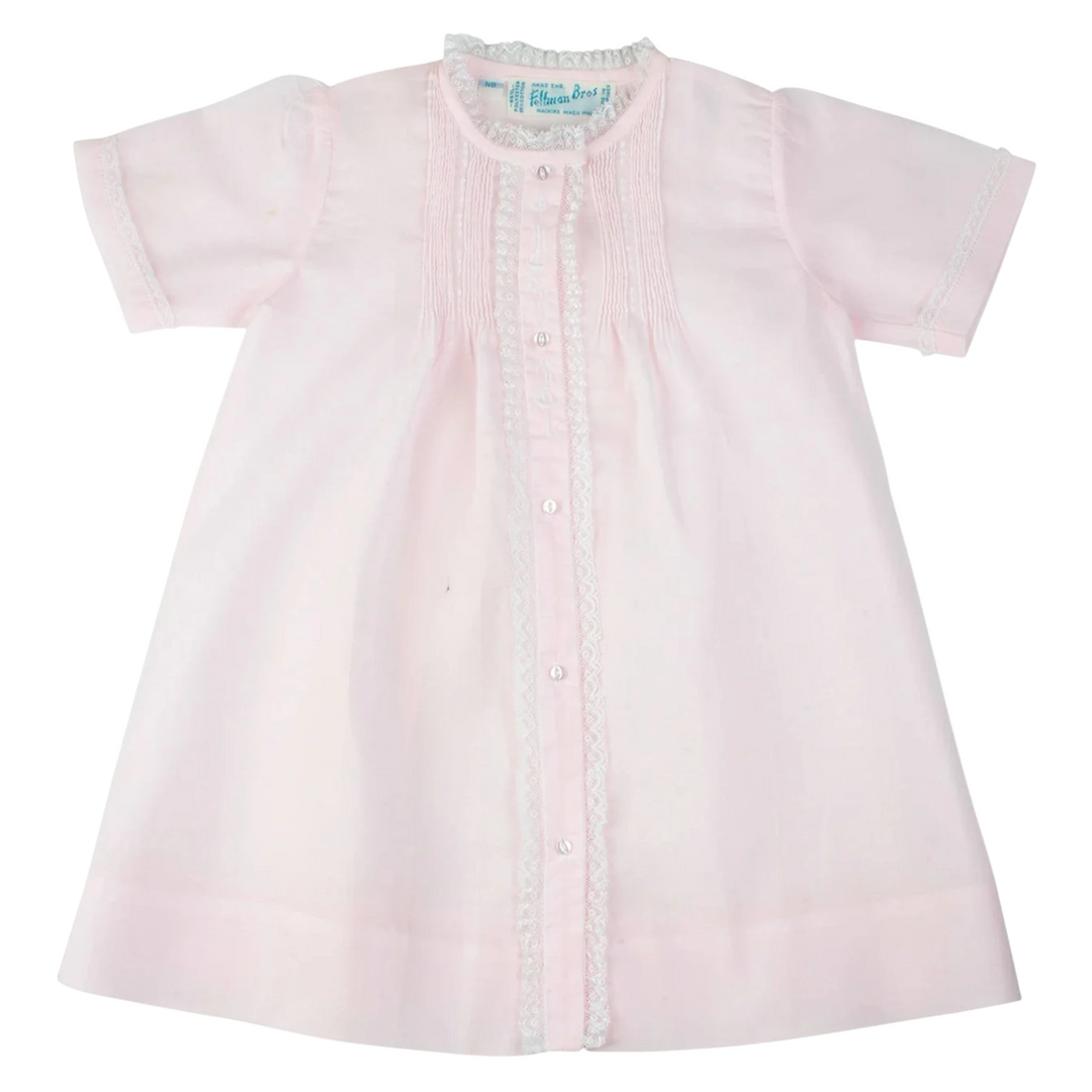 That Store vintage style pink baby daygown with fluted lace trim, hand stitched pintucks, and floral embroidery.