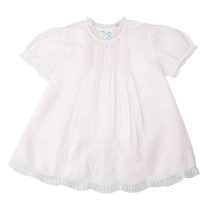 That Store pink vintage style slip dress with lace trim, pintucks, and floral embroidery for little girls.