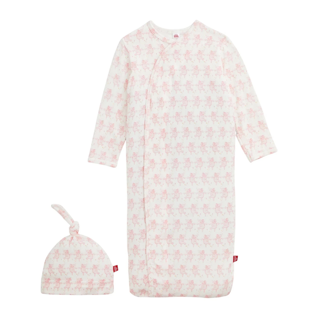 That Store pink modal magnetic baby gown and matching knotted hat with a cute repeating pig print pattern