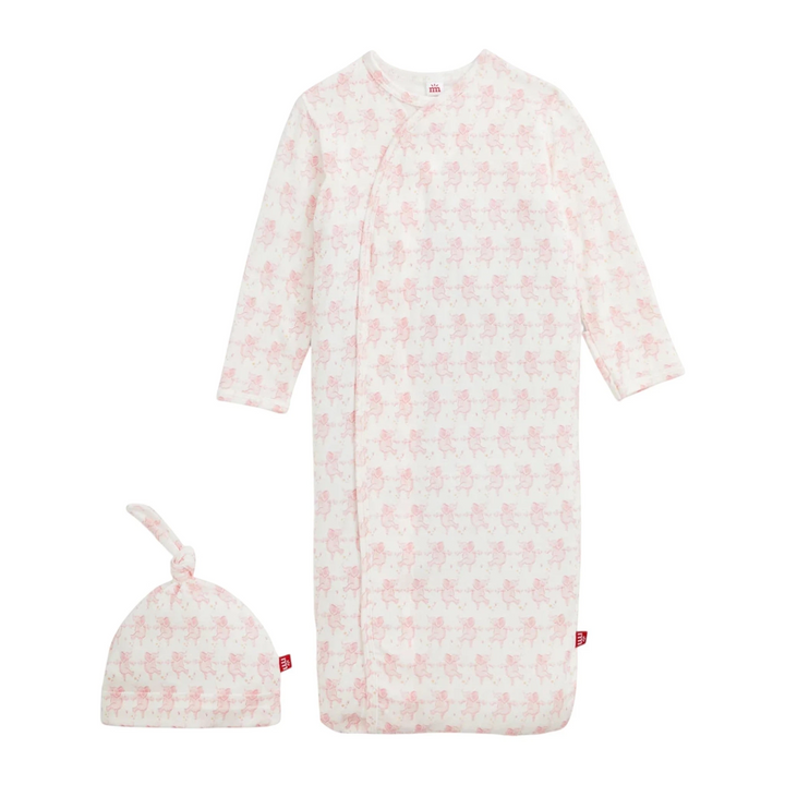 That Store pink modal magnetic baby gown and matching knotted hat with a cute repeating pig print pattern