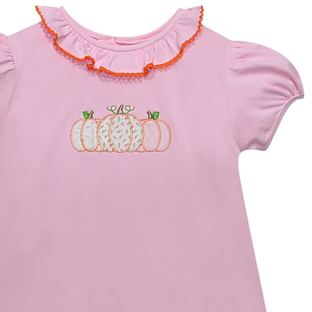 That Store toddler girl pink cotton dress featuring a pumpkin applique with floral patterns and ruffled orange collar.