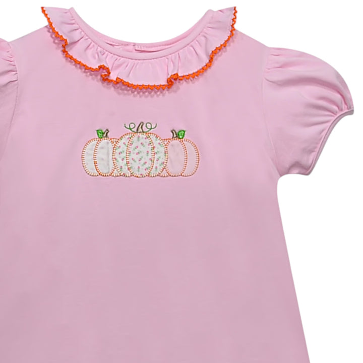 That Store toddler girl pink cotton dress featuring a pumpkin applique with floral patterns and ruffled orange collar.