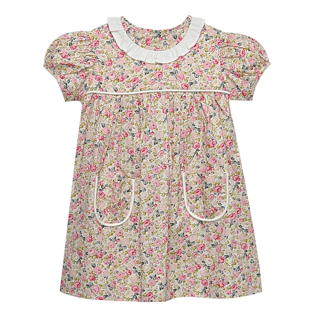 That Store Floral Pink Rose Reagan Dress with white ruffled collar, puff sleeves, and front pockets on floral fabric.